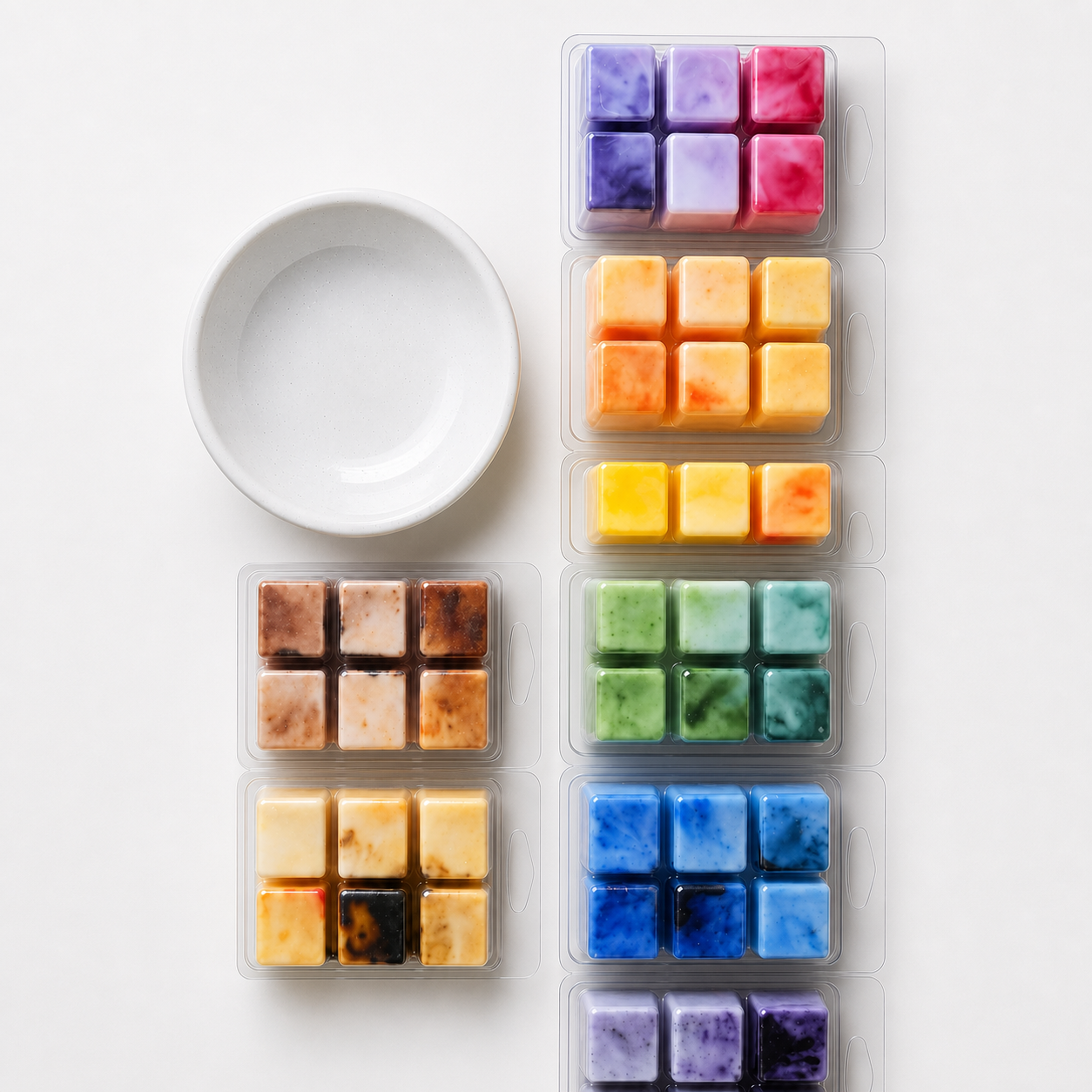 Six clear plastic trays containing small square wax melts or color chips in assorted colors, arranged vertically next to an empty white ceramic bowl on a white background.